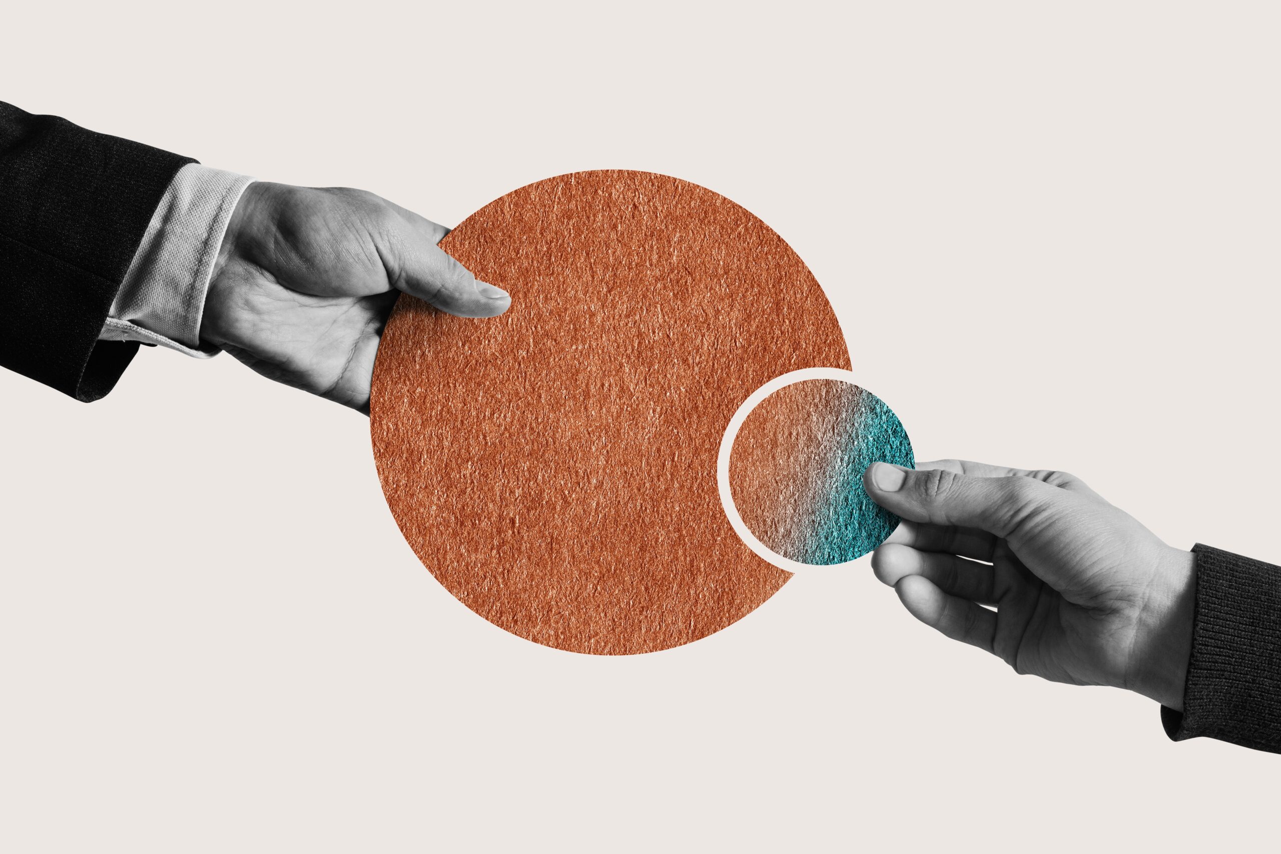 Two hands connecting a large orange circle and a smaller teal circle, symbolizing partnership or merger.