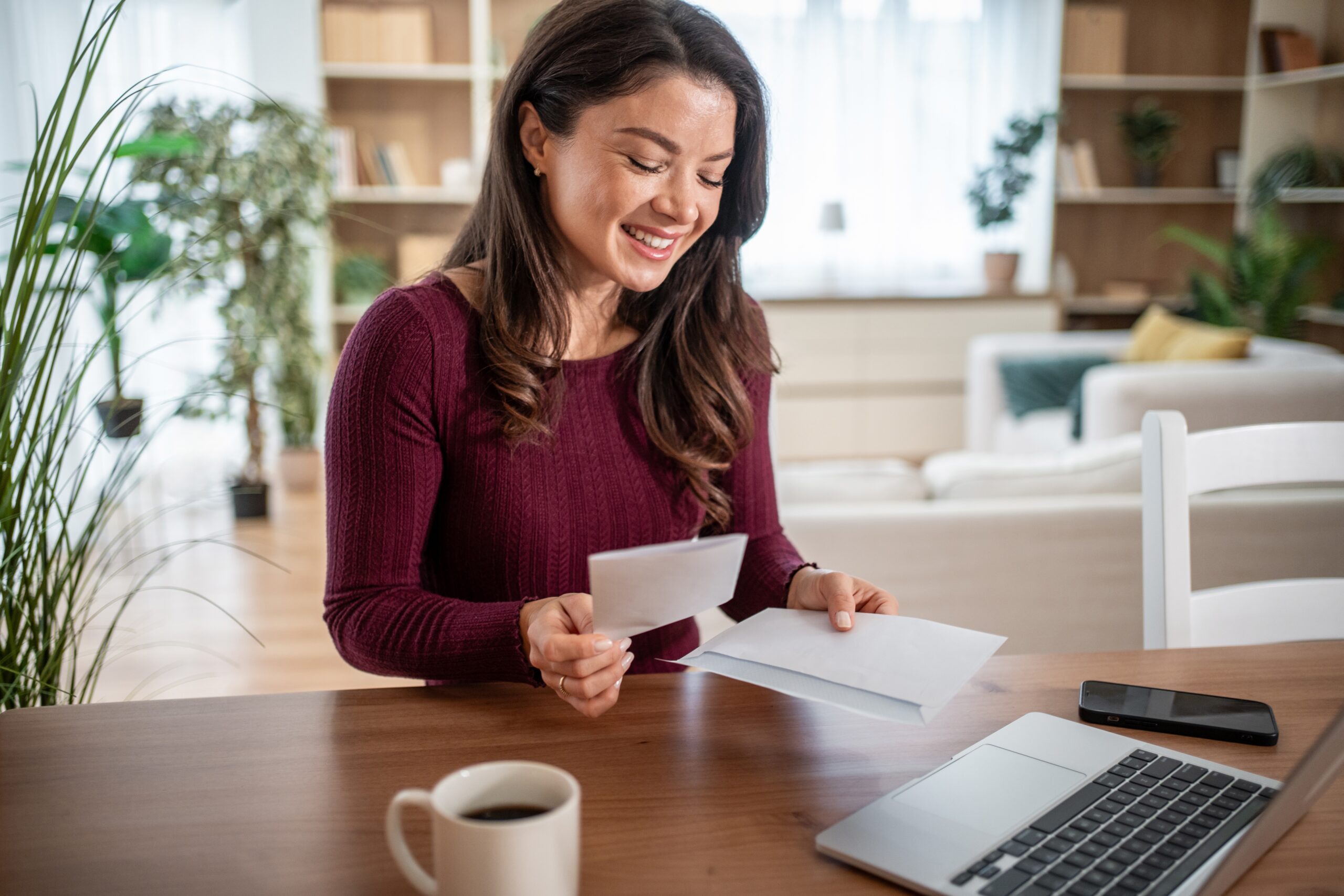 woman smiling at mail