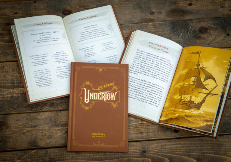 Open Undertow cocktail menu books showing illustrated storybook pages and drink lists.