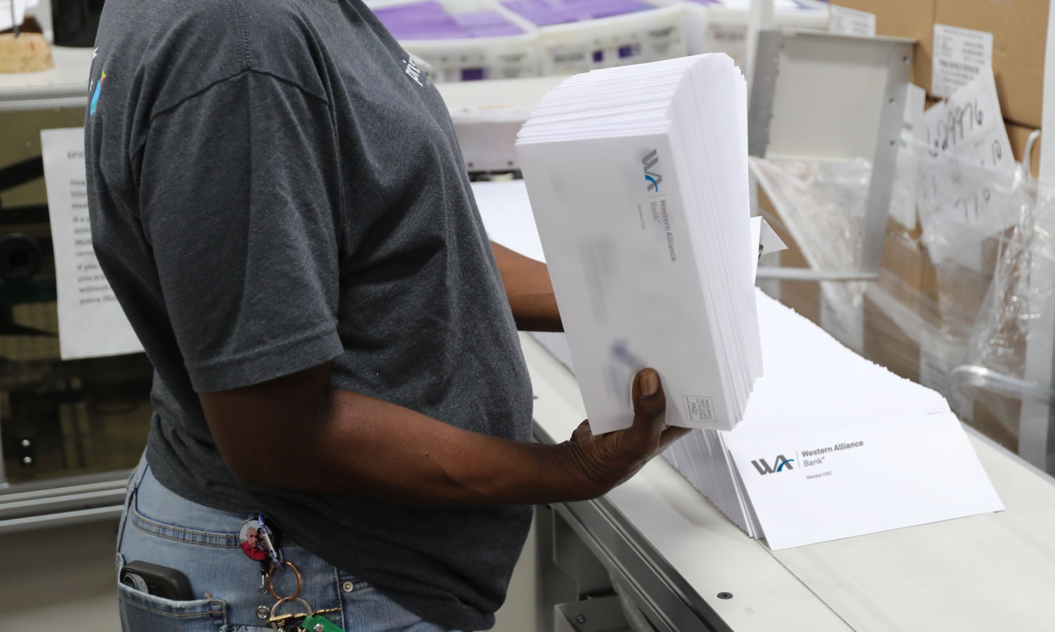 female worker holding a stack of envelopes