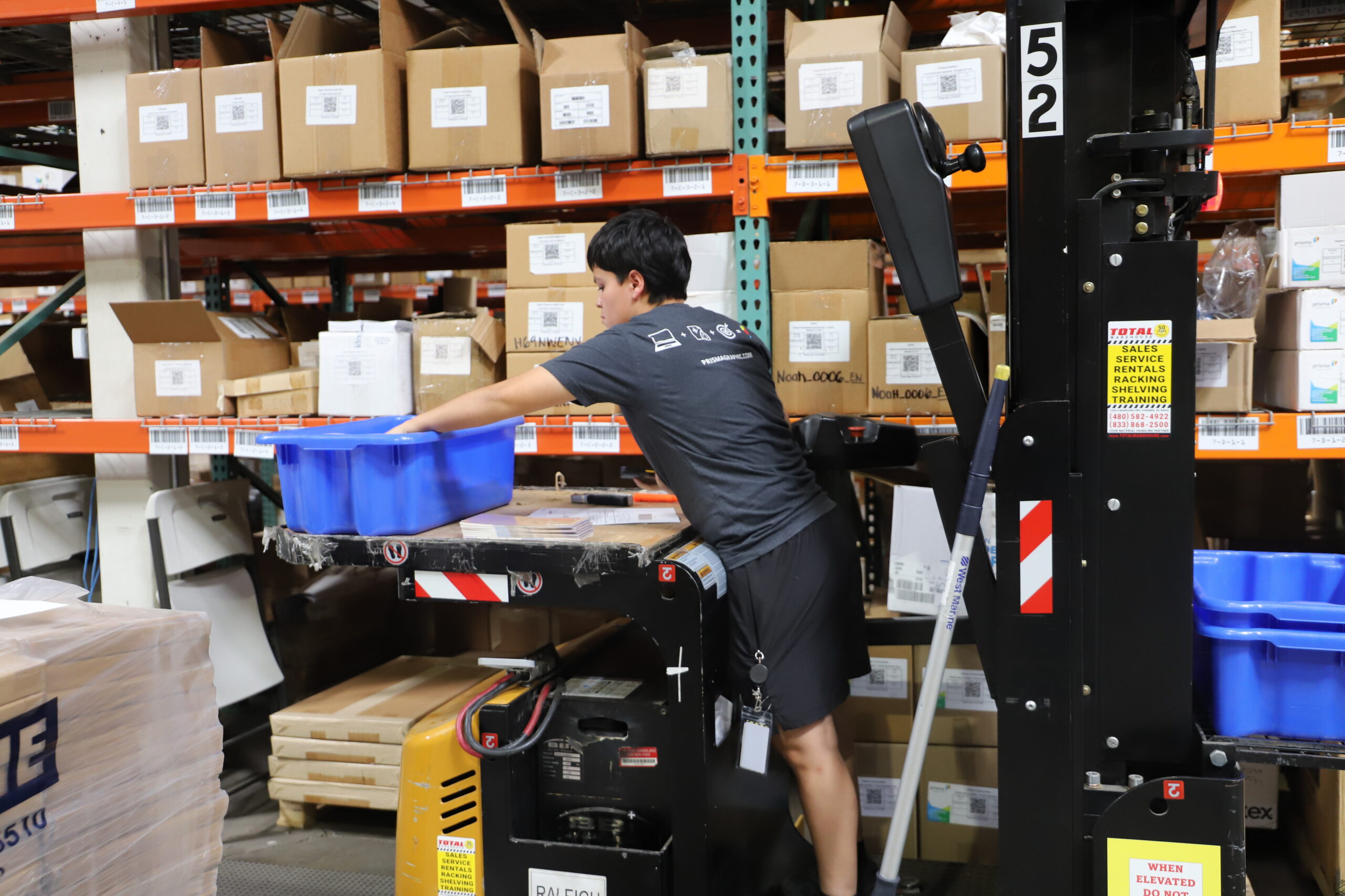 Person operating a machine in warehouse