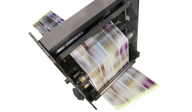 Close-up of colorful printed pages moving through a digital press at high speed.