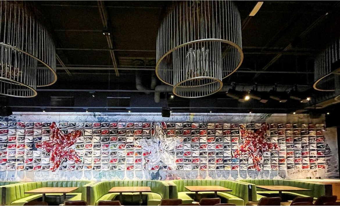 Large-format Converse sneaker mural installation at a Culinary Dropout restaurant interior.