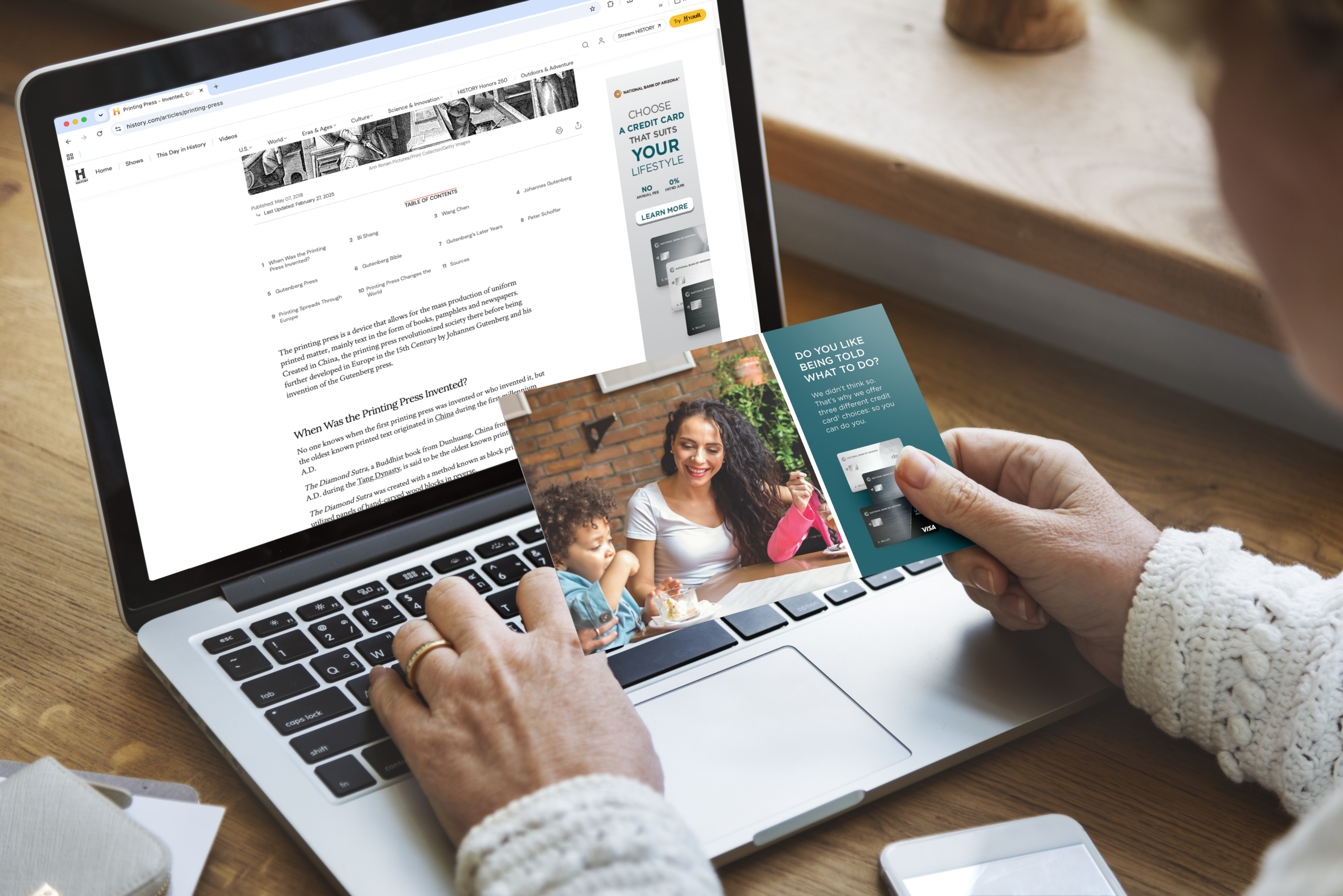 Woman on laptop with National Bank of Arizona ad on screen and matching postcard in hand