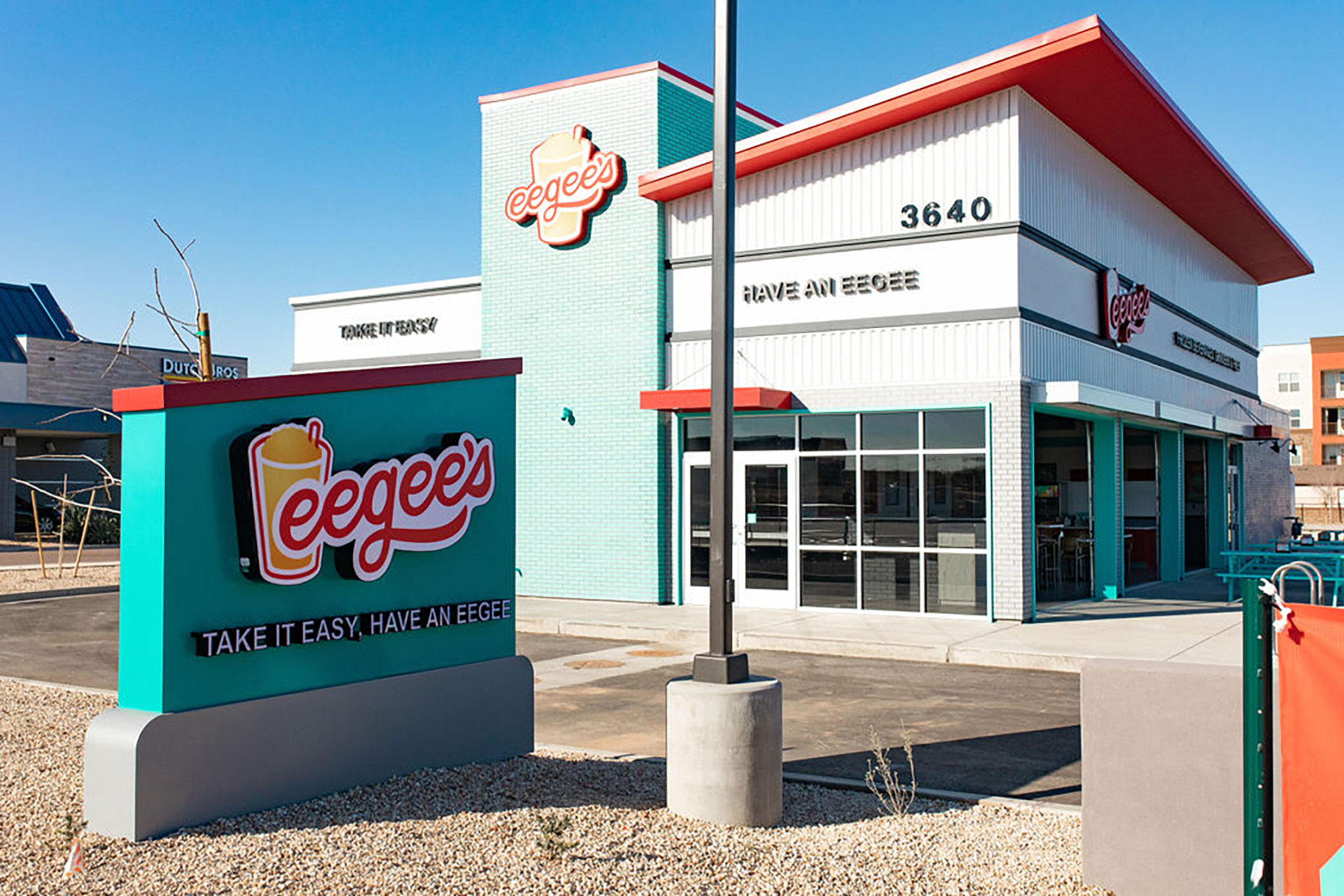 Exterior of a new eegee's restaurant with branded signage and monument sign.