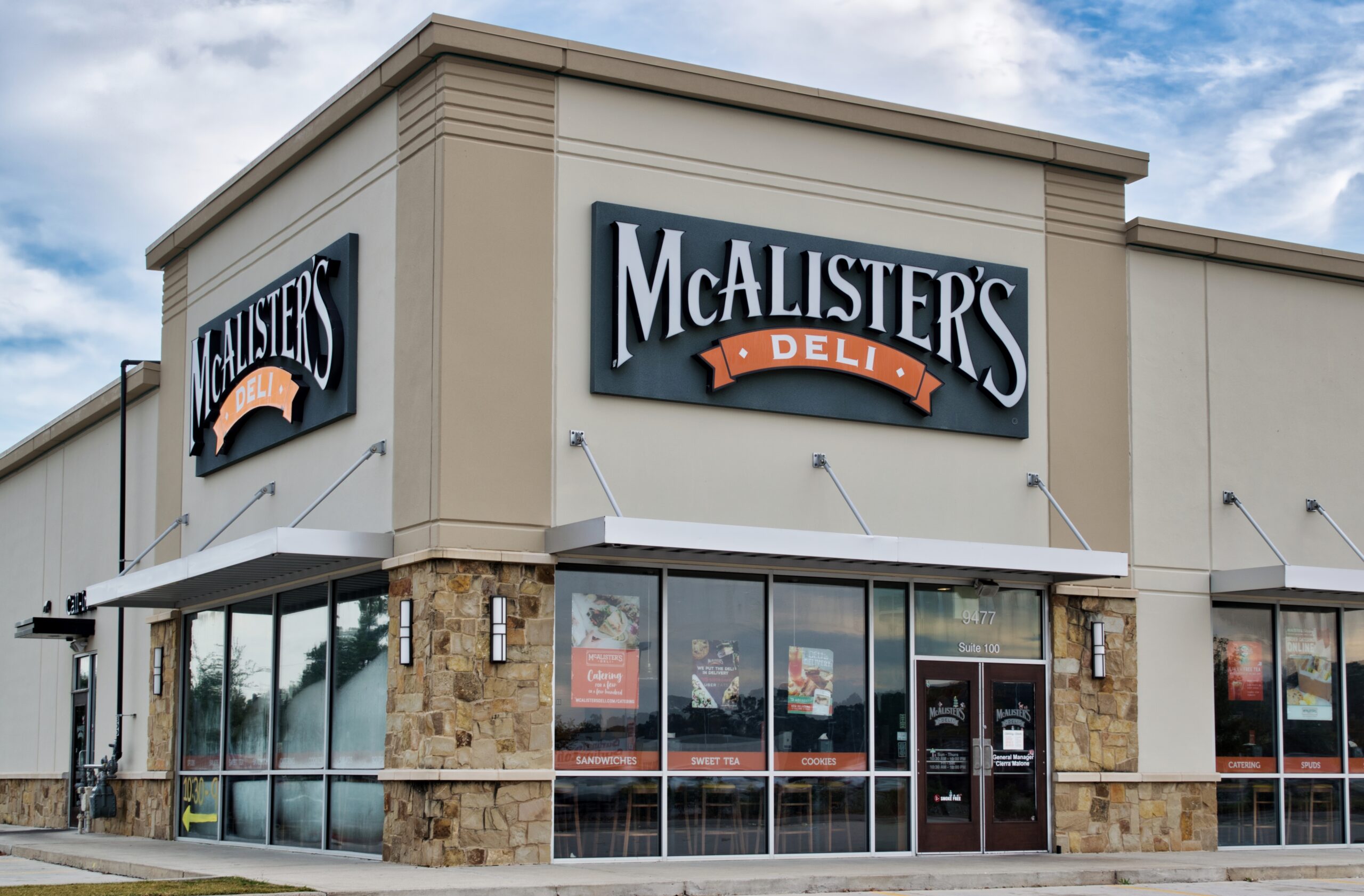 Exterior view of a McAlister's Deli restaurant location with signage and awnings.