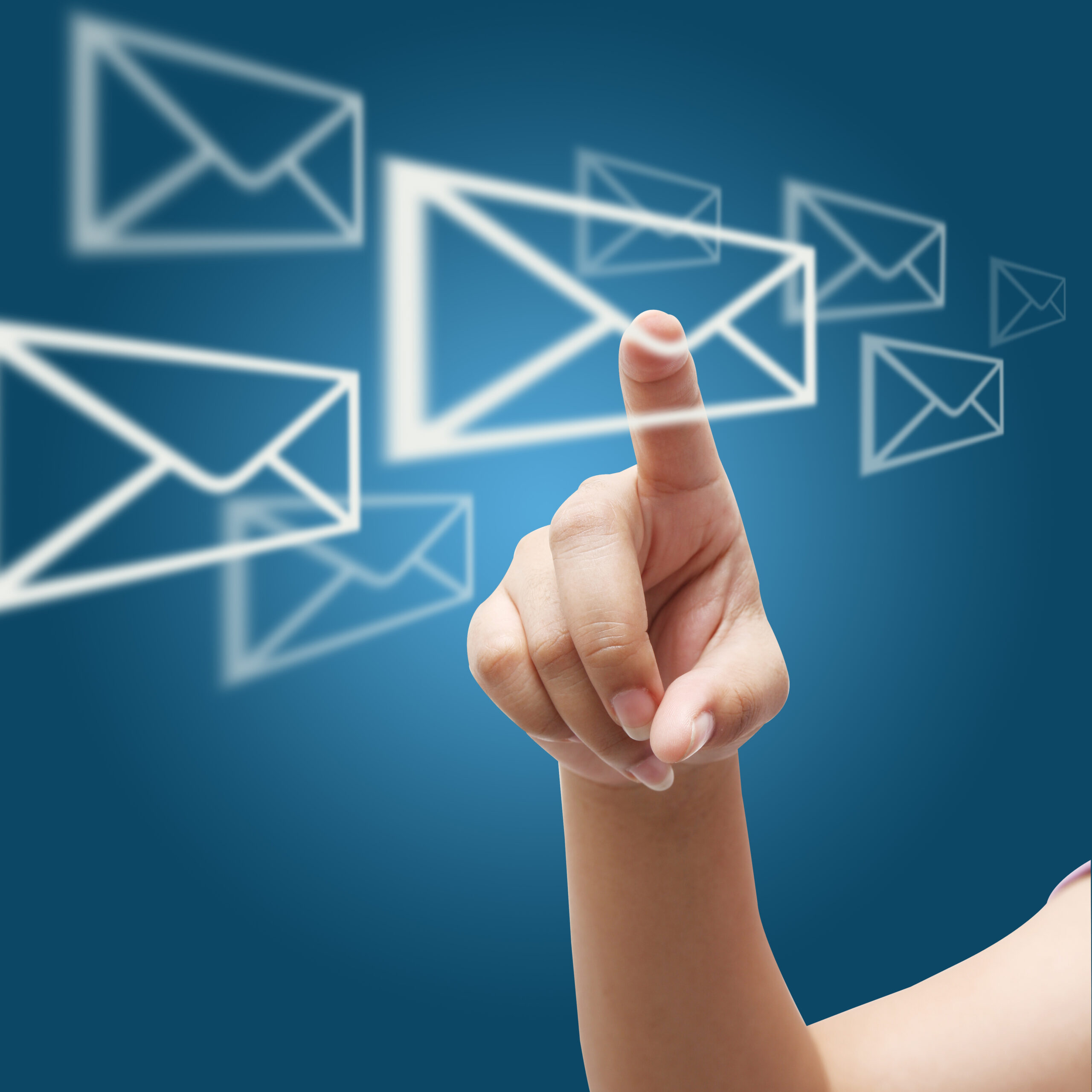 Hand pointing at glowing envelope icons flying across a blue background, symbolizing email marketing.