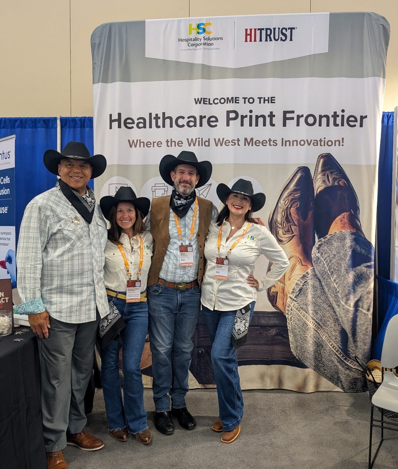 People tending at a booth at the HSC Prisma Healthcare Conference
